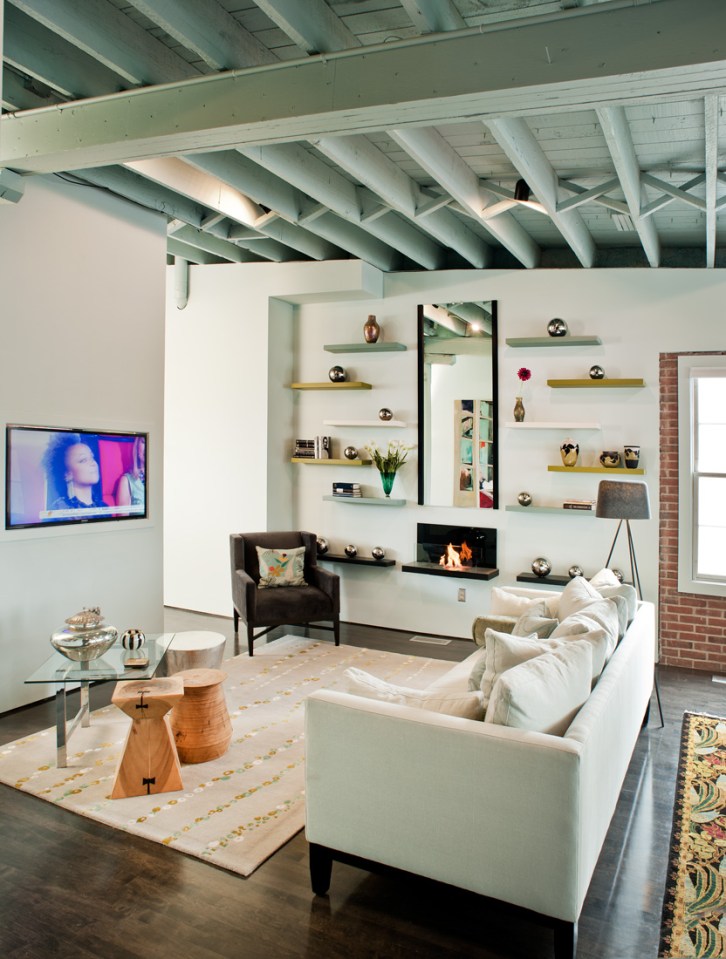 20111-2012 Loft renovation showing library wall of cantilevered, lacquered shelves and wall flame ventless fireplace